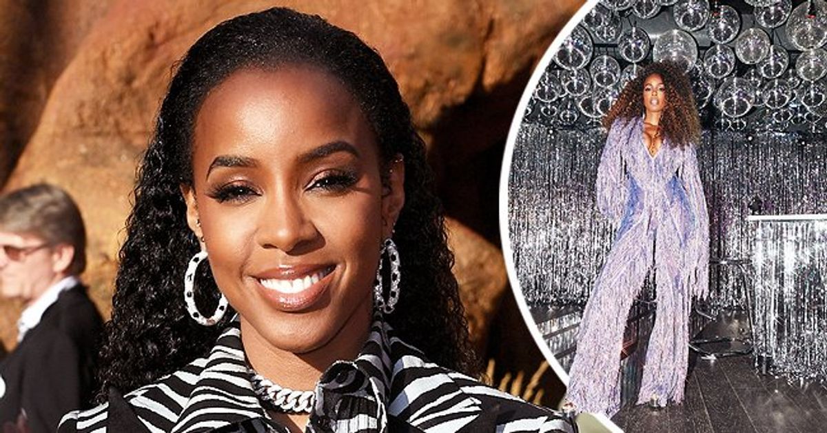 Kelly Rowland Flaunts Ample Cleavage & Curves in Purple Tassel Jumpsuit ...